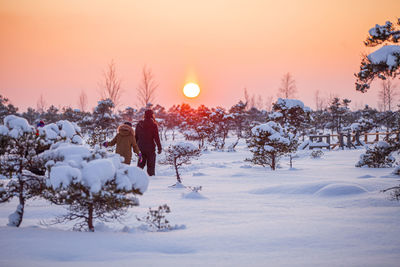 Scenic view of snow field against sky during sunset