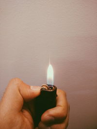 Close-up of hand holding candle