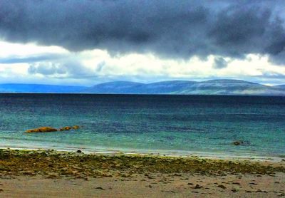 Scenic view of sea against cloudy sky