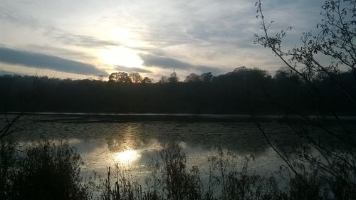 Scenic view of lake against sky during sunset
