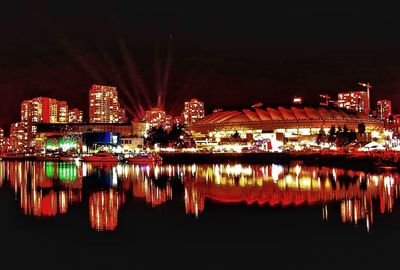 Reflection of illuminated buildings in river at night