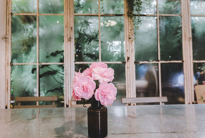 Flower vase on glass window