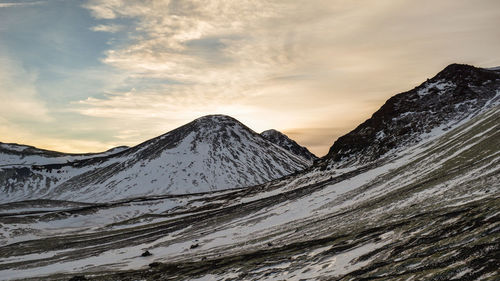 Scenic view of snowcapped mountains against sky during sunset