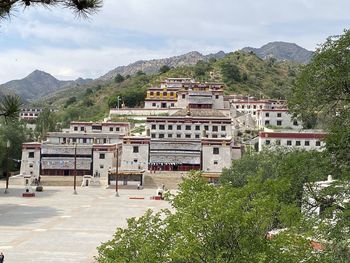 High angle view of buildings and mountains against sky