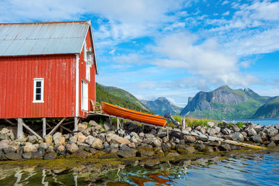 Houses by mountain against sky