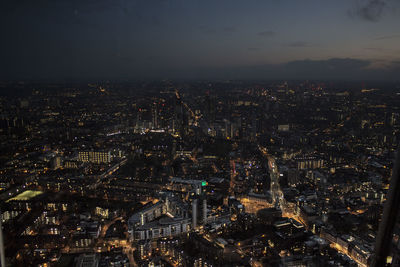 High angle view of city lit up at night