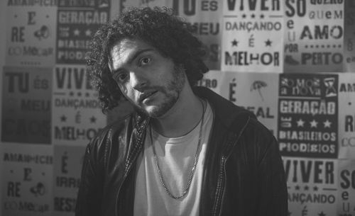 Portrait of young woman standing in city