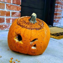 Close-up of pumpkin on stone wall during halloween