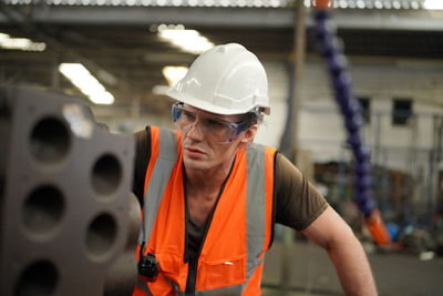 Industrial engineers in hard hats.work at the heavy industry manufacturing factory.