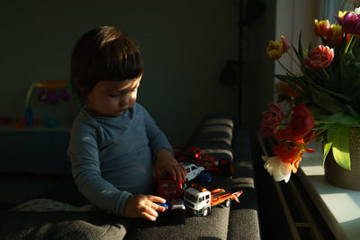 Boy holding toy at home
