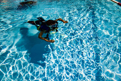 High angle view of woman swimming in pool