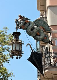 Low angle view of statue against sky in city