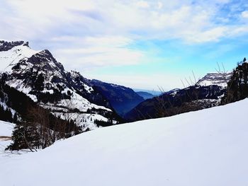 Scenic view of snowcapped mountains against sky