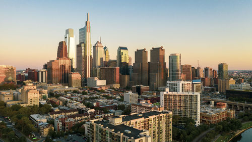 Aerial view of buildings in city against clear sky