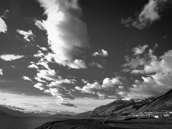Scenic view of sea and mountains against sky