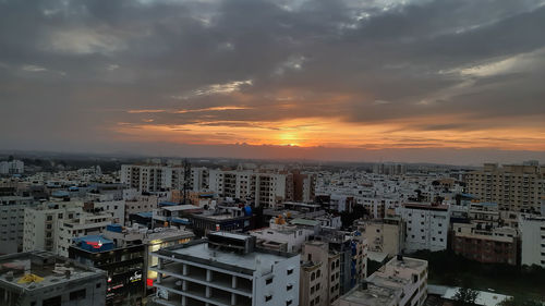 High angle view of buildings against sky during sunset