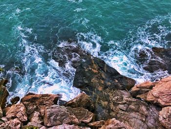 High angle view of rocks by sea