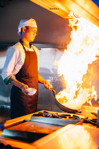 Young man preparing food in kitchen