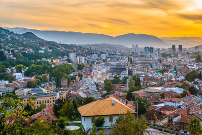 High angle shot of townscape against sky at sunset