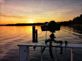 Scenic view of lake against sky during sunset