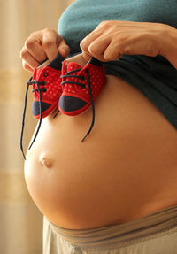 Midsection of woman holding umbrella