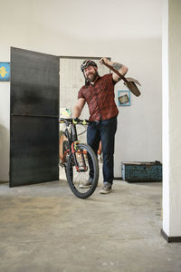 Portrait of man arriving in office with bicycle