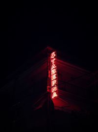 Low angle view of illuminated lights in darkroom