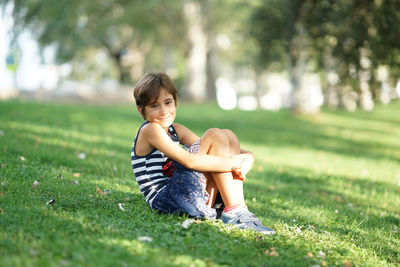 Portrait of smiling girl sitting on grass