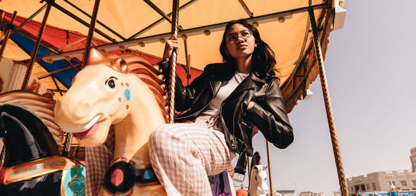 Low angle view of woman in amusement park