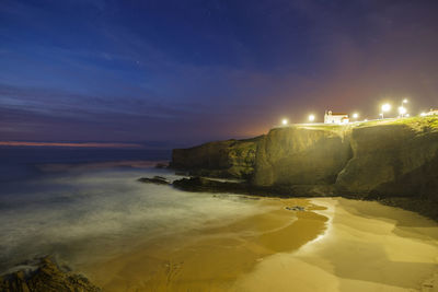 Scenic view of beach against sky at night