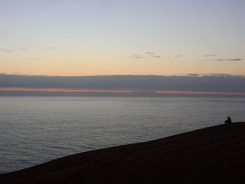 Scenic view of sea against clear sky during sunset