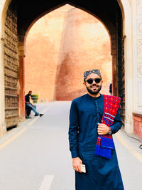 Full length of man wearing sunglasses standing outdoors