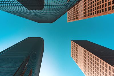 Low angle view of modern buildings against blue sky