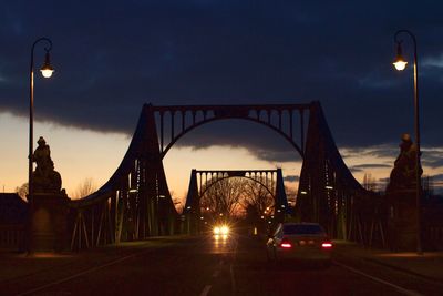 Illuminated bridge against sky at night