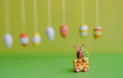 Close-up of toy against easter eggs