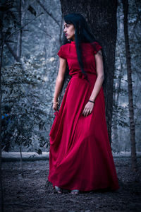 Young woman standing in forest