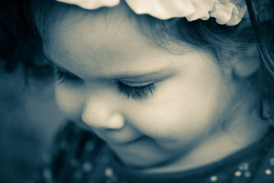 Close-up of cute girl looking down