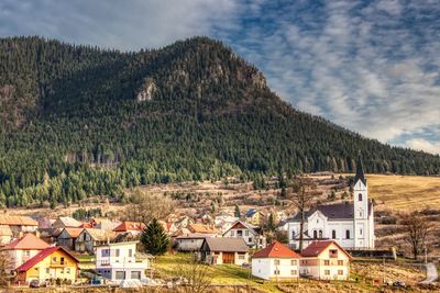 Houses on mountain against sky