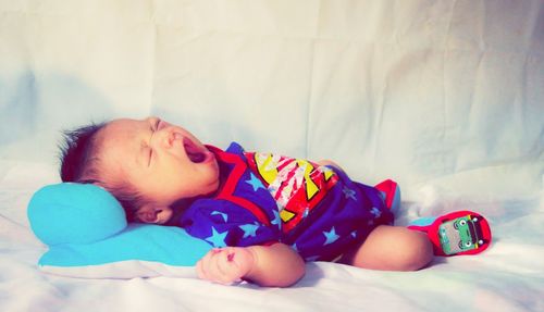 Cute baby sleeping on bed