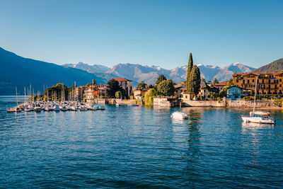 Pier on lake como with boats moored at sunset