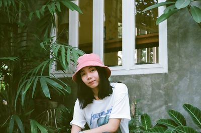 Portrait of girl standing against plants