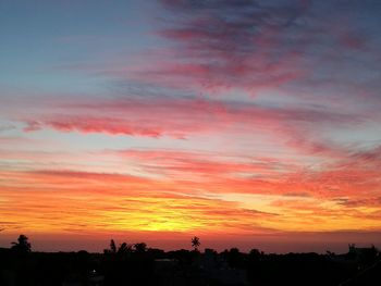 Scenic view of silhouette trees against romantic sky at sunset