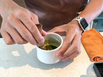 Midsection of man holding ice cream