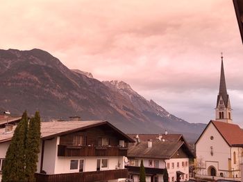 Houses and buildings in mountains against sky