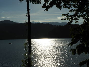 Scenic view of lake against sky at sunset