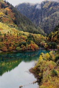 Scenic shot of calm countryside lake against mountain range