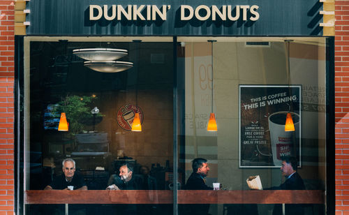 Reflection of people on glass window