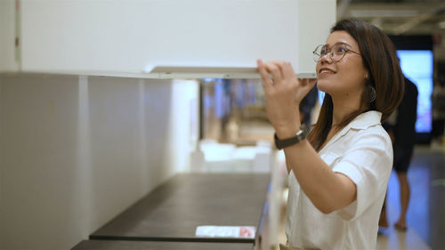 Side view of young woman looking away