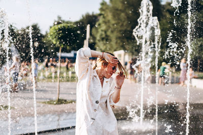 Woman standing by fountain