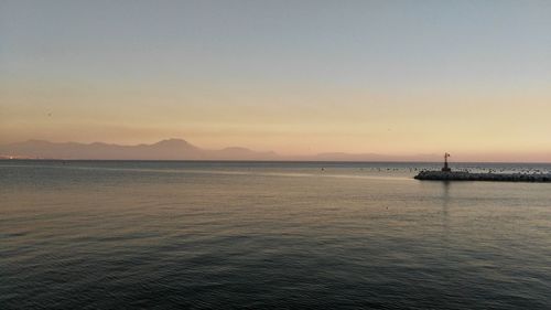 Scenic view of sea against clear sky during sunset